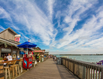 shops on the left and the ocean on the right at John's Pass